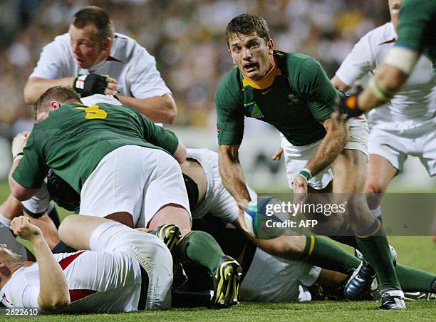 South African scrumhalf Joost van der Westhuizen clears the ball out of the scrum during the Rugby World Cup Pool C match between England and South...