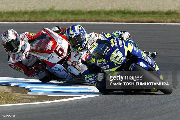 Sete Gibernau of Spain battles with Japan's Makoto Tamada during the MotoGP class Pacific Grand Prix at the Twin Ring Motegi 05 October 2003. Tamada...