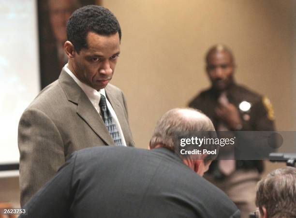Sniper suspect John Allen Muhammad looks at Prosecutor Robert Willett during the trial in courtroom 10 at the Virginia Beach Circuit Court October...