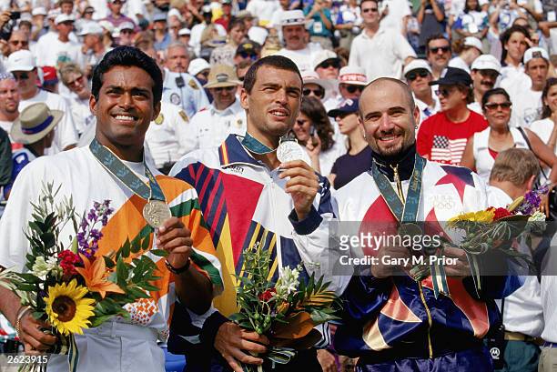 Tennis men's singles finalist, left, bronze medal winner Leander Paes of India, center, silver medal winner Sergi Bruguera of Spain and, right, gold...