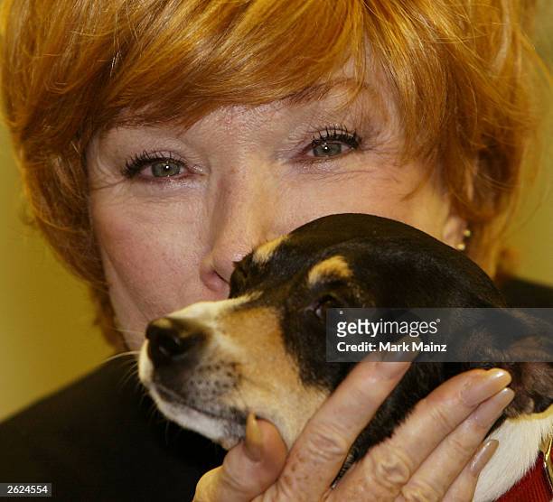 Actress Shirley Maclaine strokes a dog at a signing for her new book 'Out on a Leash' at Barnes and Nobles, Rockefeller Centre on October 21, 2003 in...