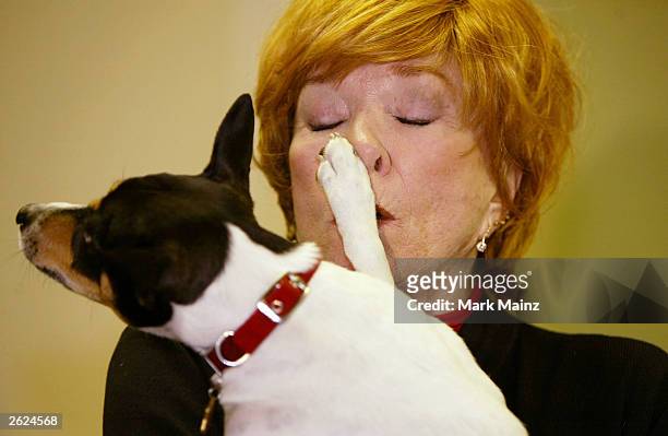 Actress Shirley Maclaine holds a dog at a signing for her new book 'Out on a Leash' at Barnes and Nobles, Rockefeller Centre on October 21, 2003 in...