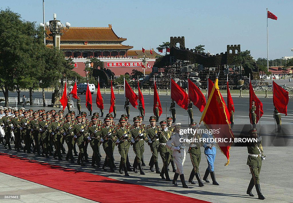 Chinese military honour guards march pas