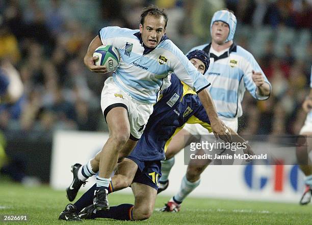 Juan Hernandez of Argentina slips the tackle of Iulian Andrei of Romania during the Rugby World Cup Pool A match between Argentina and Romania at...