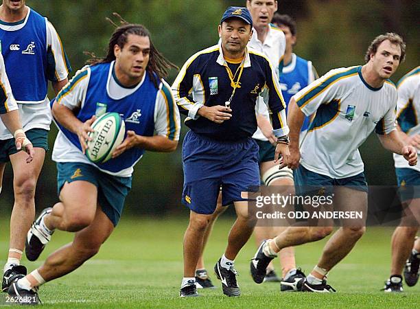 Australian national coach Eddie Jones and teammates watch flanker George Smith runs with the ball during a training session in Coffs Harbour, 20...
