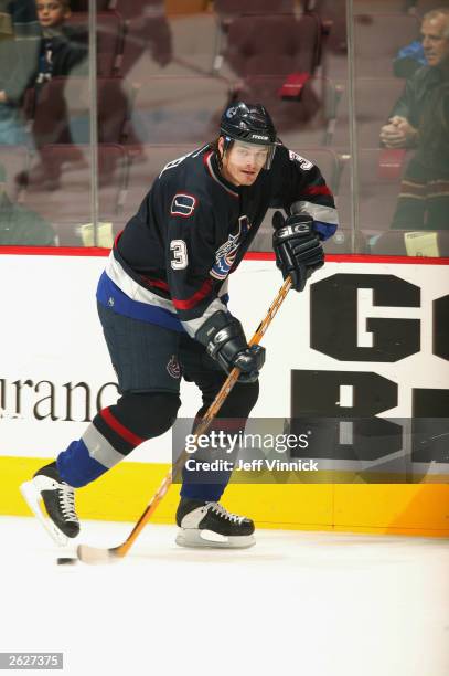 Defenseman Brent Sopel of the Vancouver Canucks skates with the puck against the Edmonton Oilers during the NHL game on October 11, 2003 at General...