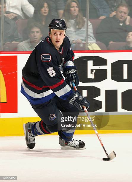 Defenseman Sami Salo of the Vancouver Canucks skates with the puck against the Edmonton Oilers during the NHL game on October 11, 2003 at General...