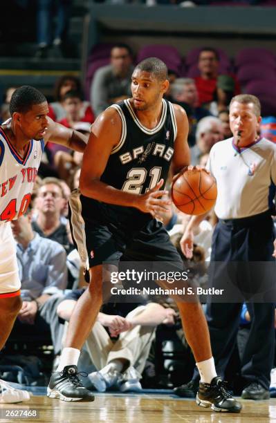 Tim Duncan of the San Antonio Spurs is defended by Kurt Thomas of the New York Knicks during the preseason game at Madison Square Garden on October...