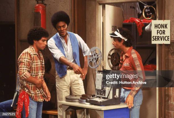 'Sweathogs' Robert Hegyes, Lawrence Hilton-Jacobs and Ron Palillo examine a film projector in a still from the television series, 'Welcome Back...