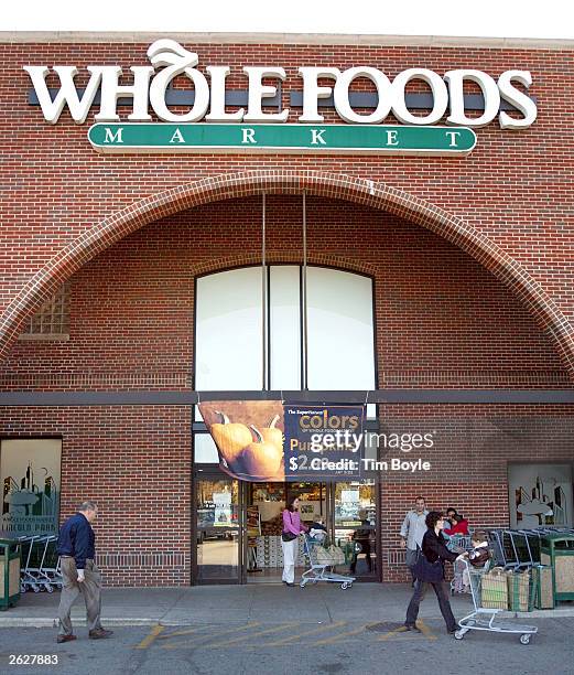 Consumers exit and enter a Whole Foods Market store October 22, 2003 in Chicago. Austin, Texas-based Whole Foods Market has planned to become the...