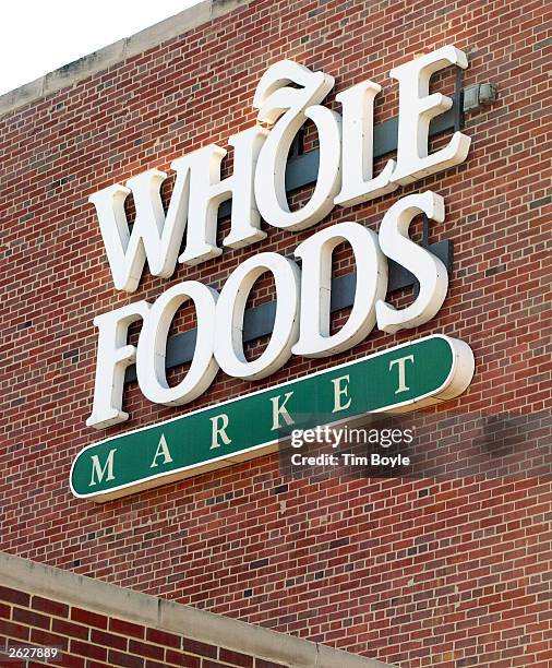 Consumers exit and enter a Whole Foods Market store October 22, 2003 in Chicago. Austin, Texas-based Whole Foods Market has planned to become the...