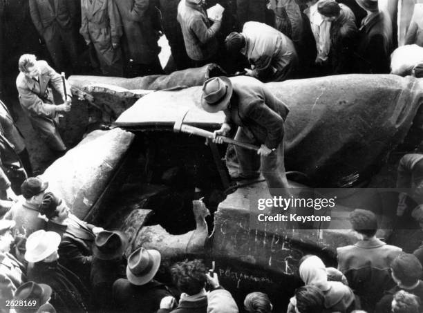 Hungarian nationalists break up a statue of Joseph Stalin in Budapest during the civil war.