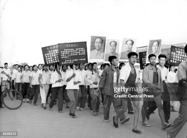 Red Guards carry portraits of their Communist leader Mao as they parade through Peking to the Soviet Embassy in protest at 'Soviet Revisionism'.