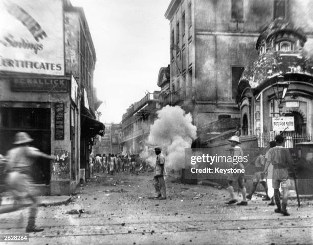 Calcutta policemen use tear gas bombs during the communal riots in the city. The communal riots lasted 5 days; at least 2,000 were killed, and over...