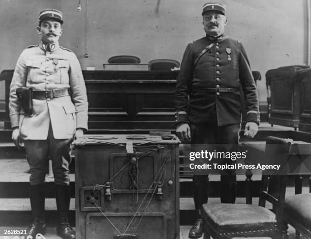 Two guards stand next to the oven in which murderer Henri Desire Landru was supposed to have burned his victims' bodies. Known as the French...