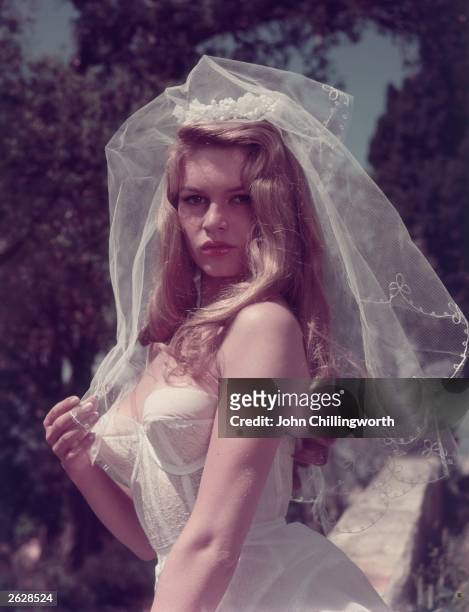 French actress Brigitte Bardot, nicknamed the Sex Kitten, wearing a wedding veil. Original Publication: Picture Post - 8546 - Brigitte Bardot - unpub.