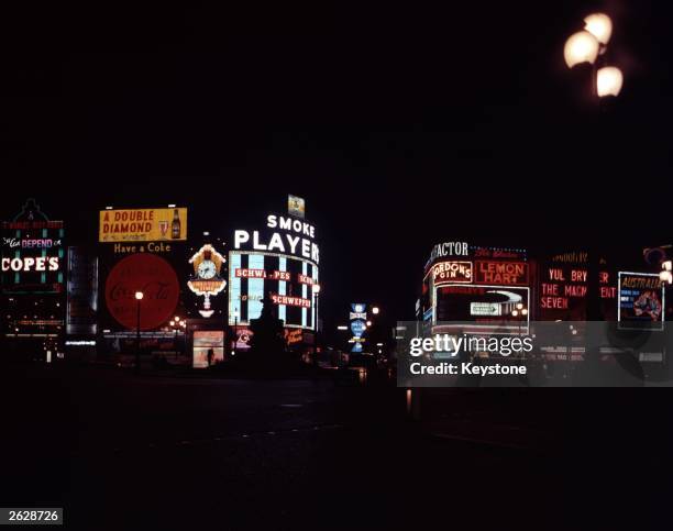 Illuminated advertisements surrounding the statue of Eros in Piccadilly Circus, London.