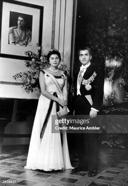 Shah Mohammad Reza Pahlavi of Persia with his wife Queen Soraya after arriving in England for an informal visit. Original Publication: Picture Post -...