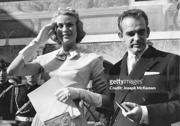 Prince Rainier of Monaco with Grace Kelly, the American film actress and his future bride, receiving gifts on the eve of their wedding. Original...