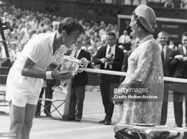 Australian tennis player John Newcombe receiving the men's singles trophy from HRH Princess Marina after his victory over Wilhelm Bungert of Germany...