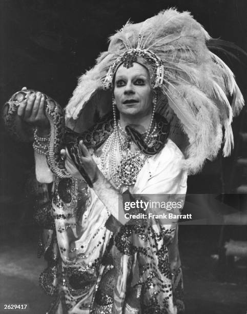 Lindsay Kemp, Scottish mime artist, actor and director, holds a boa constrictor as he plays the title role in 'Salome', at The Round House, London.