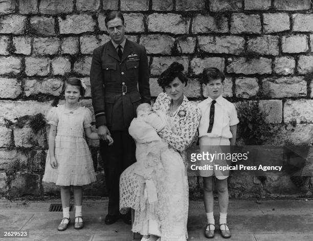The Duke of Kent, George Edward Alexander Edmund, with the Duchess and their children at the christening of their third baby . Original Publication:...