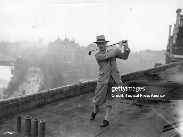 American golfer Robert Tyre , best known as Bobby Jones practising his swing on the roof of the Savoy Hotel in London. Jones is one of the American...