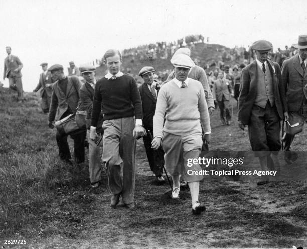 Hartley walks with the American golfer Bobby Jones to the next green during the Walker Cup contest at Royal St George's Links at Sandwich.