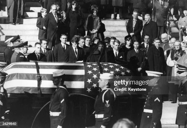 Jacqueline Kennedy, Edward Kennedy and Robert Kennedy stand as the coffin of President John Fitzgerald Kennedy passes them. Original Publication:...