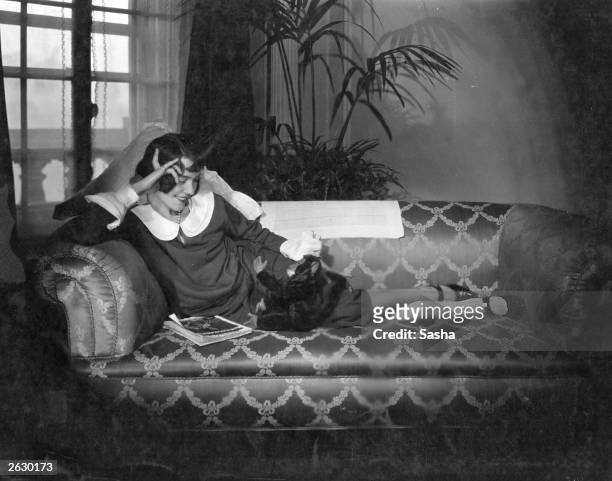 Actress Adele Astaire relaxing with her toy monkey. Original Publication: People Disc - HS0046