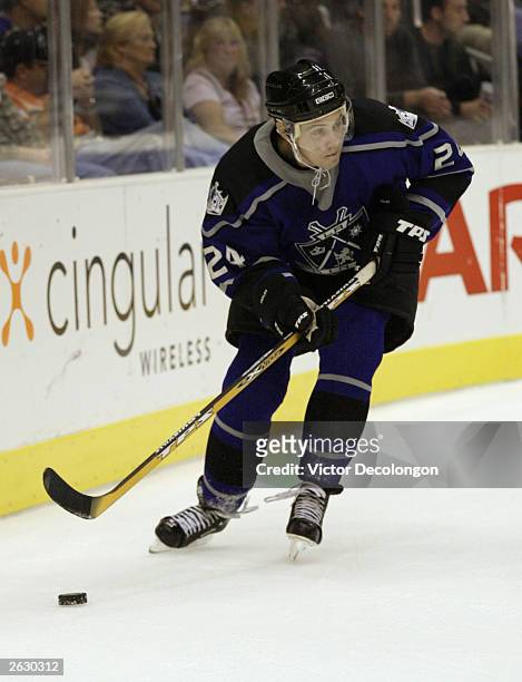 Alexander Frolov of the Los Angeles Kings looks to make a play from behind the net in the third period of a game against the Ottawa Senators on...
