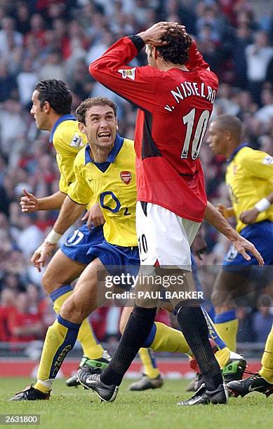 Martin Keown of Arsenal taunts Ruud Van Nistelrooy of Manchester United after a missed a penalty given away by Keown in the final minutes of their...