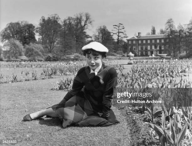Actress Audrey Hepburn relaxes in Kew Gardens after a strenuous season in the London revue 'Sauce Piquante', 13th May 1950. Picture Post - 5035 - We...