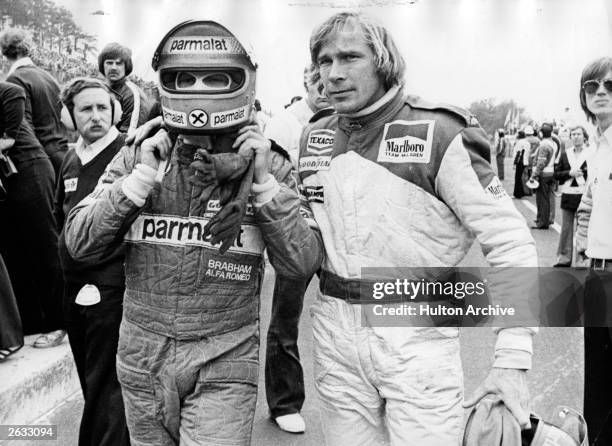 British racing driver James Hunt and Austrian Niki Lauda abandoning the race after they have crashed into each other. Original Publication: People...