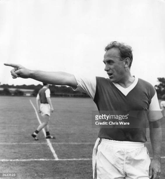 Footballer Billy Wright, the new manager of Arsenal Football Club in north London, directs a training session at the club's grounds at Highbury....