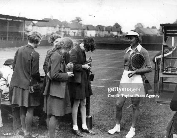 American tennis player Alice Marble poses for fans' photographs at the Surrey championships' Ladies semi-finals. Original Publication: People Disc -...