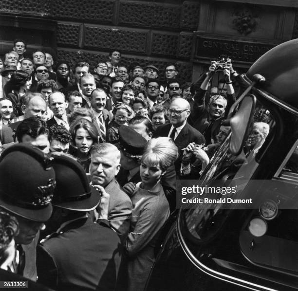 Christine Keeler and Mandy Rice-Davies jostled by the crowds and reporters as they leave the Old Bailey during the trial of Dr Stephen Ward, a major...