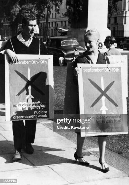 British author and playwright and actor John Osborne and his wife Mary Ure take part in a 'Ban the H-Bomb Campaign' in Whitehall, London, during...