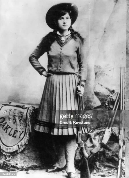 Rodeo star Annie Oakley , who was famous as a highly skilled trick shooter with the Buffalo Bill Wild West Show. One of her tricks was to shoot...