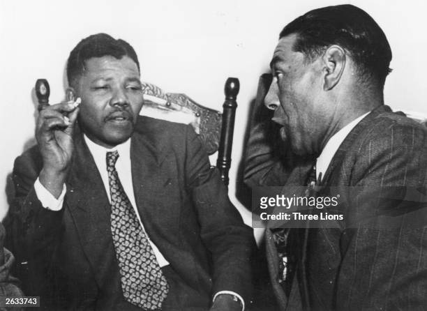 South African anti-apartheid activist, Nelson Mandela, of the African National Congress in discussion with C. Andrews, a Cape Town teacher, circa...