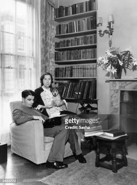 Welsh playwright and actor Emlyn Williams seated at home with a typewriter on his knee. Original Publication: People Disc - HK0203