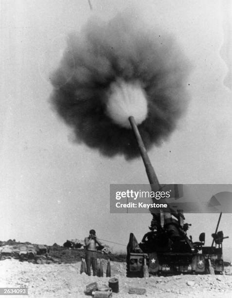 An American 175 mm projectile blasts from a gun at Camp Carroll in the Qang Tri Province near the Demilitarized Zone during the Vietnam War.
