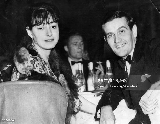 American journalist, writer and wit Dorothy Parker , at a restaurant. With her husband, Alan Campbell. Original Publication: People Disc - HK0426