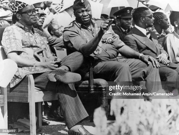 Idi Amin, President of Uganda, with President Mobutu Sese Seko of Zaire, previously Joseph Desire Mobutu, watching a military parade in Kampala.