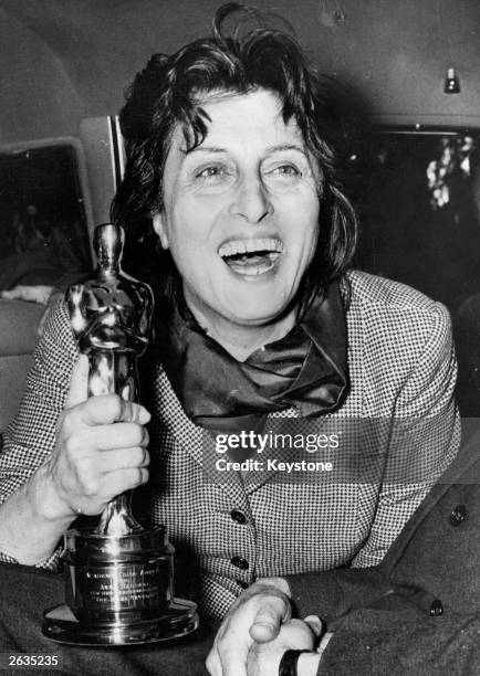 Egyptian-born Italian actress Anna Magnani holding the Oscar she won for her performance in 'Rose Tattoo', presented to her by the US Ambassador...