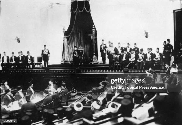 King Ahmed Fuad I at the opening ceremony of the Egyptian parliament. Reading the speach is Prime minister Adli Yegen, with members of the Cabinet...