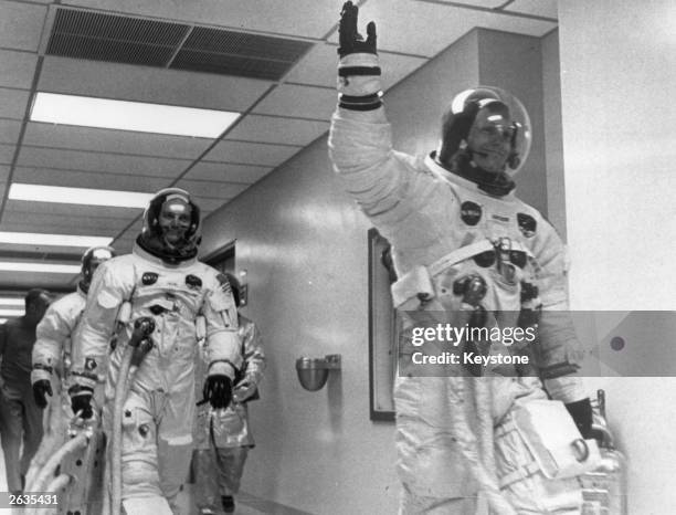 Neil Armstrong leads Edwin 'Buzz' Aldrin and Michael Collins out of the space centre on the Apollo 11 space mission to the moon.