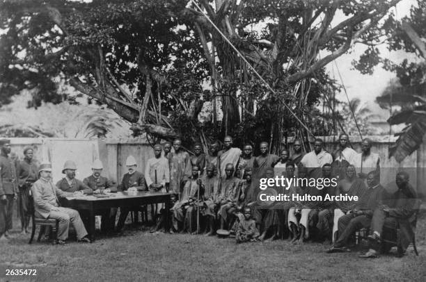 Colonial administrators in Lagos, Nigeria, with messengers from the interior.