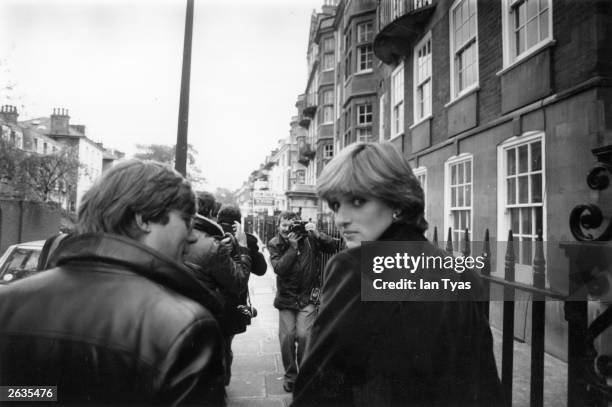 Lady Diana Spencer , surrounded by press photographers and reporter Howard Foster shortly before the announcement of her engagement to Charles,...