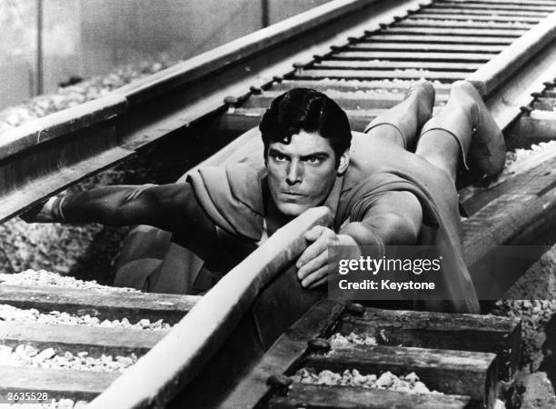 Year-old American actor Christopher Reeve plays the comic-book hero as he mends a broken railway track in a scene from the film 'Superman'.